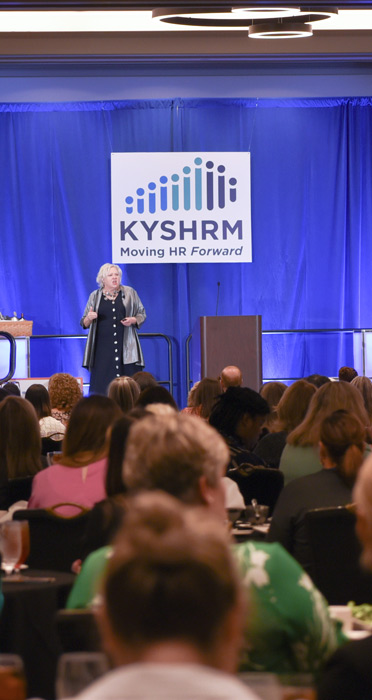 Speaker on stage at KYSHRM Conference